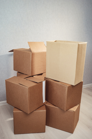 Moving in. Stack of cardboard boxes in the empty room.の写真素材