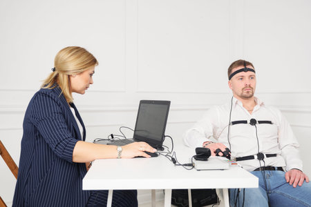 businessman sits for a lie detector examination.