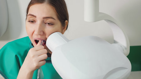 young woman is doing tooth x-ray in dental clinic, close-up