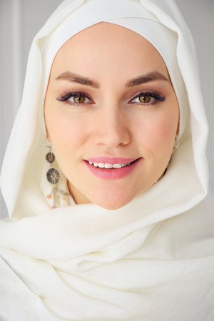 Portrait closeup of muslim woman in hijab smiling and looking at camera, close upの写真素材