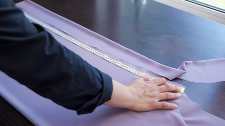 Cutting and sewing products in tailoring business. Dressmaker creating new clothes. Seamstress makes...