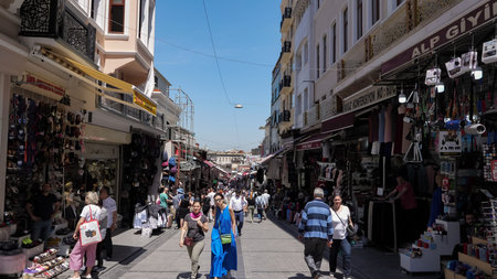 ISTANBUL, TURKEY - JULY 30 2019: Crowd of tourists and locals walks past different shops on Istanbul...