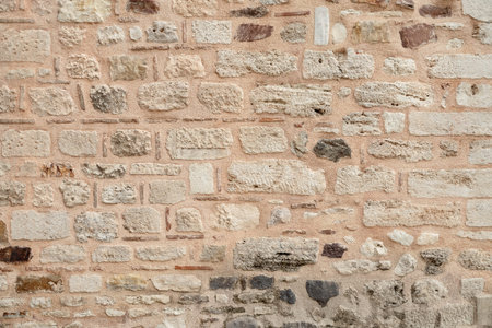 wall of the historical building is made of different stones. Texture.