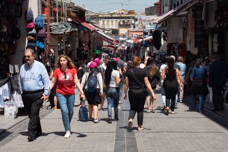 ISTANBUL, TURKEY - JULY 30 2019: Crowd of tourists and locals walks past different shops on Istanbul pedestrian street under clear blue sky on sunny dayのeditorial素材