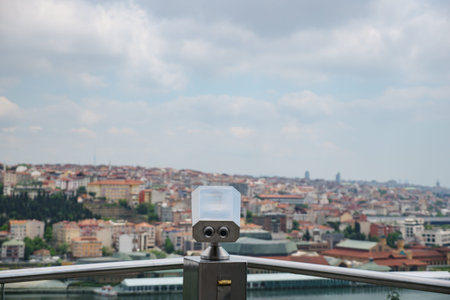 Paid binoculars on the observation deck on the background of the city.