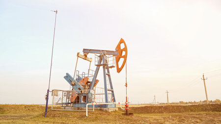 Oil drilling derricks oilfield. Crude oil production from the ground, sunlight