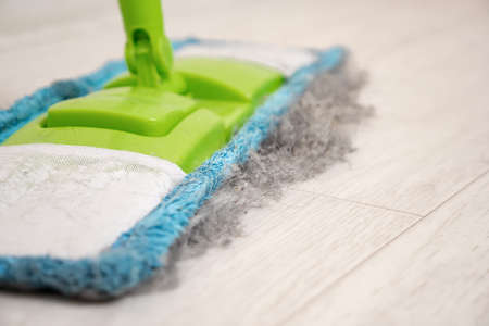 Close-up of a mop with collected debris from hair, wool, dust.の写真素材