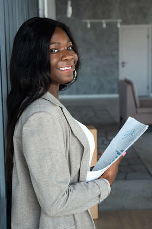 african american woman in a business suit with papers in hands.の写真素材