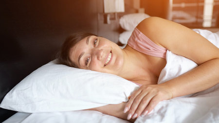 Resting peacefully in comfortable hotel bed, tourist enjoying serene vacation moment, waking up with...