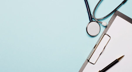 Stethoscope, paper and pen on a light blue background. Copy space. Flat layの写真素材