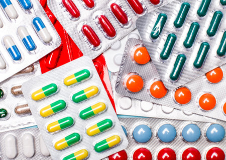 Pharmaceuticals, antibiotics, tablets, medications. Colorful antibacterial pills on a dark...