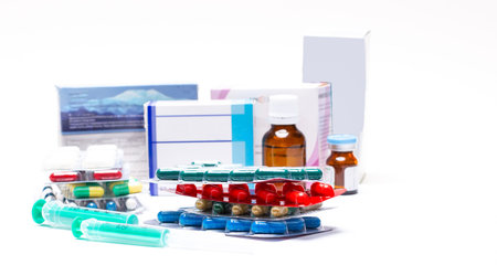 Various medical bottles and pills, ampoules on a white background. Defocus. Pharmaceuticals,...