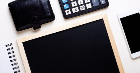 White office desk with copy space, pen, wallet, and supplies. Top view with copy space.