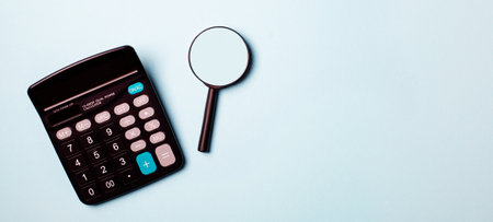 Magnifying glass with calculator on report.blue toneの写真素材