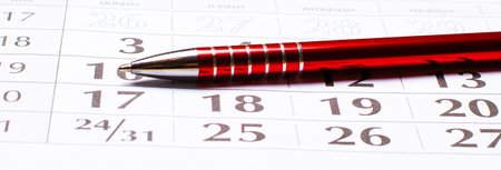On the table is a 2021 calendar and a beautiful red pen. Organizational conceptの写真素材