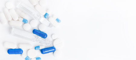 Pharmaceuticals, antibiotics, tablets, medicines. White and blue antibacterial pills on a light background. Capsules, tablets, medicinesの写真素材