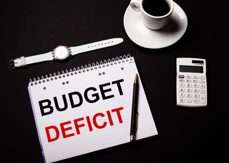 Calculator with BUDGET DEFICIT on display isolated on white background