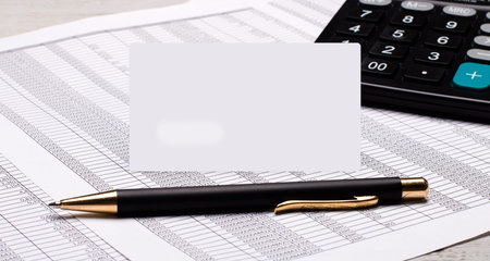 On the desktop there are reports, a calculator, a pen and a white card with a place to insert text...