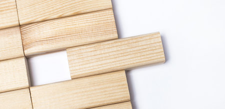 On a light background, wooden blocks with a place to insert text. Close-up top view. Template