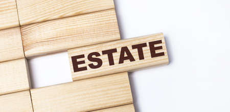 On a light background, wooden blocks with the text ESTATE. Close-up top view.の写真素材