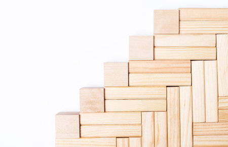 On a light background, wooden blocks and cubes with a place to insert text. Template