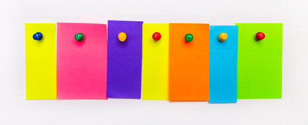 On a white background, bright multi-colored strips of paper with a place to insert text are fixed with buttons. Templateの写真素材