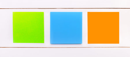 On a white background, orange, blue and green stickers with a place to insert text. Template