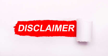 On a bright red background, white paper with a torn stripe and the inscription DISCLAIMERの写真素材