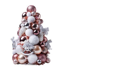 Christmas tree decorated with pink and white decor on a white background. A place to copy. Isolate on a white background. Christmas concept. Bannerの写真素材