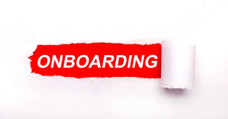 On a bright red background, white paper with a torn stripe and the inscription ONBOARDINGの写真素材