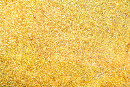 golden glitter texture background. Sparkling glitter wrapping paper for the holidays. Wallpaper...