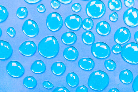 Gel blue drops forming a background. The concept of protection against viruses or cosmetics. The perfect backdrop for a presentationの写真素材