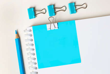 Stationery blue paper clips, a pencil and blue paper on a light background. copy spaceの写真素材