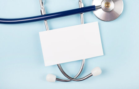 Stethoscope and white paper with space to insert text on a blue background. copy spaceの写真素材