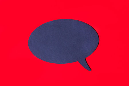 A black curly card with a place to insert text on a bright red background. Top view with a place to copyの写真素材