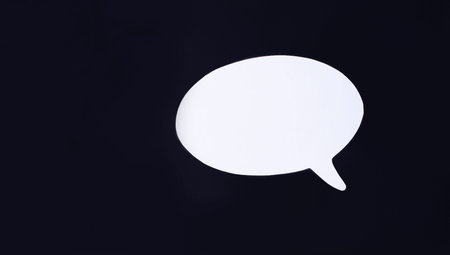 White curly card with space to insert text on a black background. top view with copy space