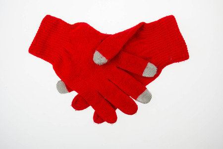 Pair of woman knitted gloves isolated on whiteの写真素材