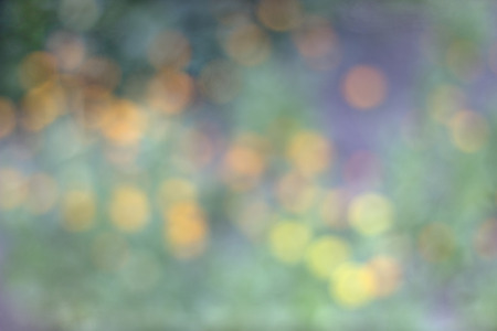 Abstract blurred colored bokeh mood dim background for wallpaper and postcardの写真素材