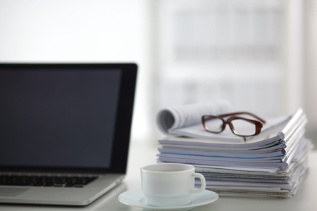 newspaper,eyeglasses, cup and laptop.の写真素材