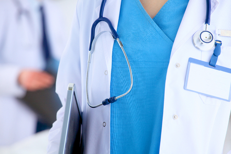 Woman doctor standing with stethoscope at hospital .の写真素材