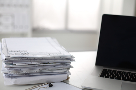 office desk a stack of computer paper reports work forms.の写真素材