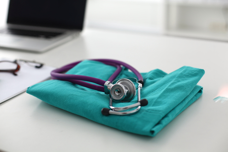 Doctor clothes lying on the table with a stethoscope.の写真素材