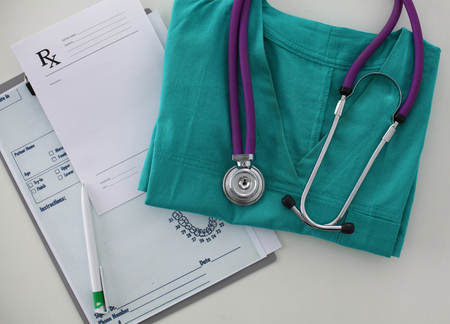 Doctor clothes lying on the table with a stethoscope.の写真素材