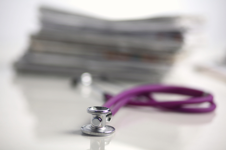Medical stethoscope on the stack of paper .の写真素材