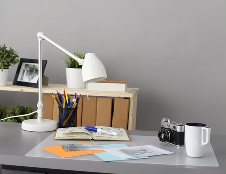 Designers table with camera and tools, cup.の写真素材