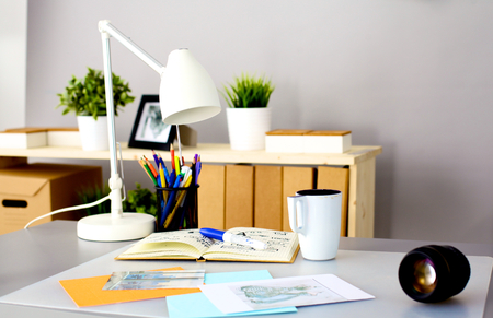 Designers table with camera and tools, cup.の写真素材