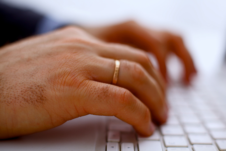 Man's hands typing on laptop. Internet surfing.の写真素材