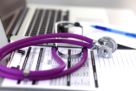 Violet stethoscope on a laptop computer .の写真素材