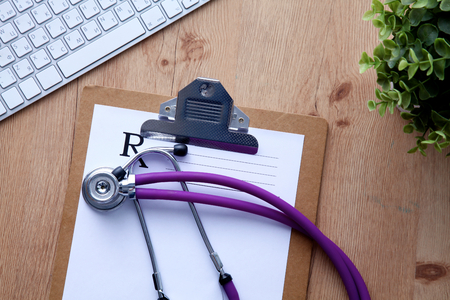 Violet stethoscope on a laptop computer .の写真素材