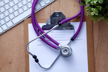 Violet stethoscope on a laptop computer .の写真素材